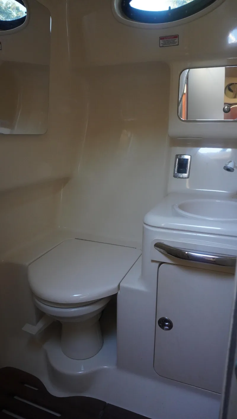 Slide: The Image of 2002 Sea Ray 340 Amberjack bathroom with toilet, sink, and mirror. - 40