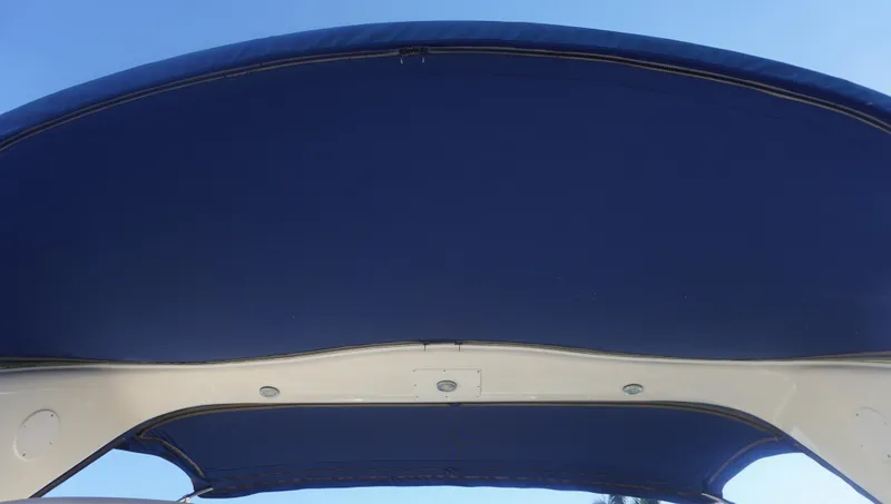 Slide: The Image of Blue canopy of 2002 Sea Ray 340 Amberjack boat against clear sky. - 42