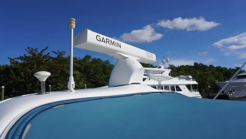 Slide: The Image of Sea Ray 340 Amberjack 2002 with Garmin radar, docked under clear blue sky. - 43