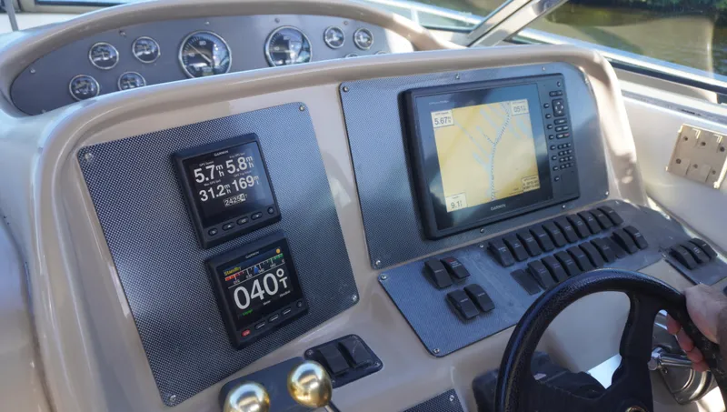 Slide: The Image of Dashboard of 2002 Sea Ray 340 Amberjack with navigation instruments and controls. - 47