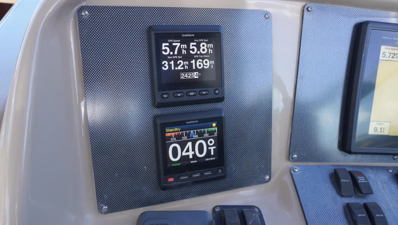 Slide: The Image of Close-up of navigation instruments on a 2002 Sea Ray 340 Amberjack boat dashboard. - 48