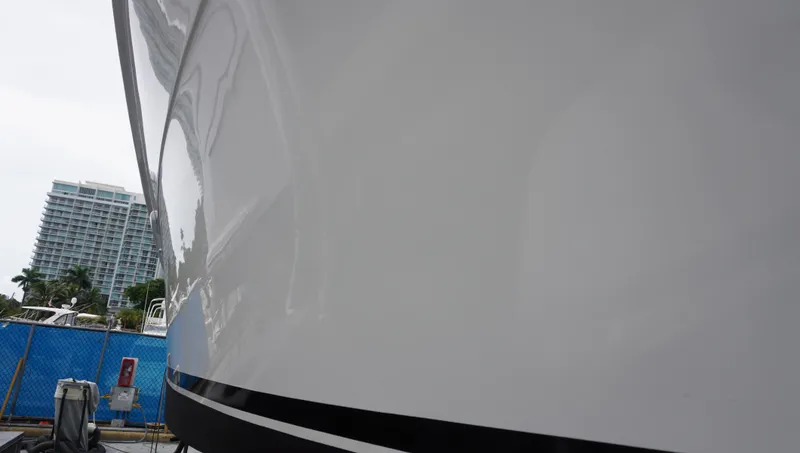 Slide: The Image of Close-up of a 2002 Sea Ray 340 Amberjack boat hull with cityscape background. - 7