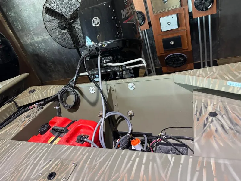 Slide: The Image of 2024 Tracker Grizzly 1648 SC boat interior with engine and wiring. - 5