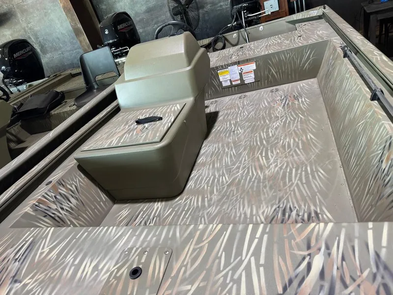 Slide: The Image of 2024 Tracker 1648 SC boat interior with camouflage design and seating. - 7