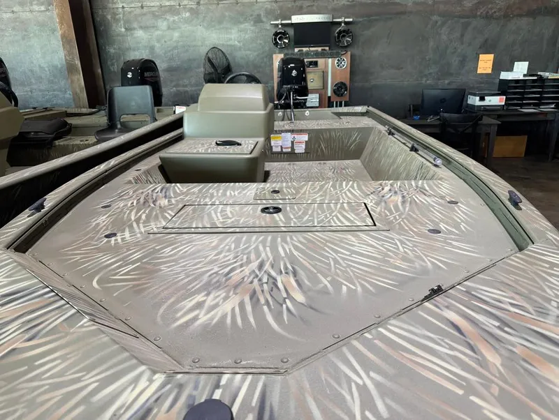 Slide: The Image of 2024 Tracker 1648 SC boat with camouflage design in showroom. - 8