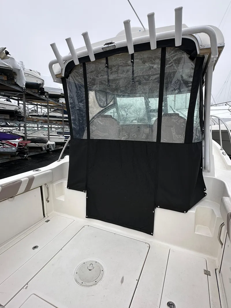 Slide: The Image of 2017 Striper 270 Walkaround boat with covered cockpit and rod holders. - 11