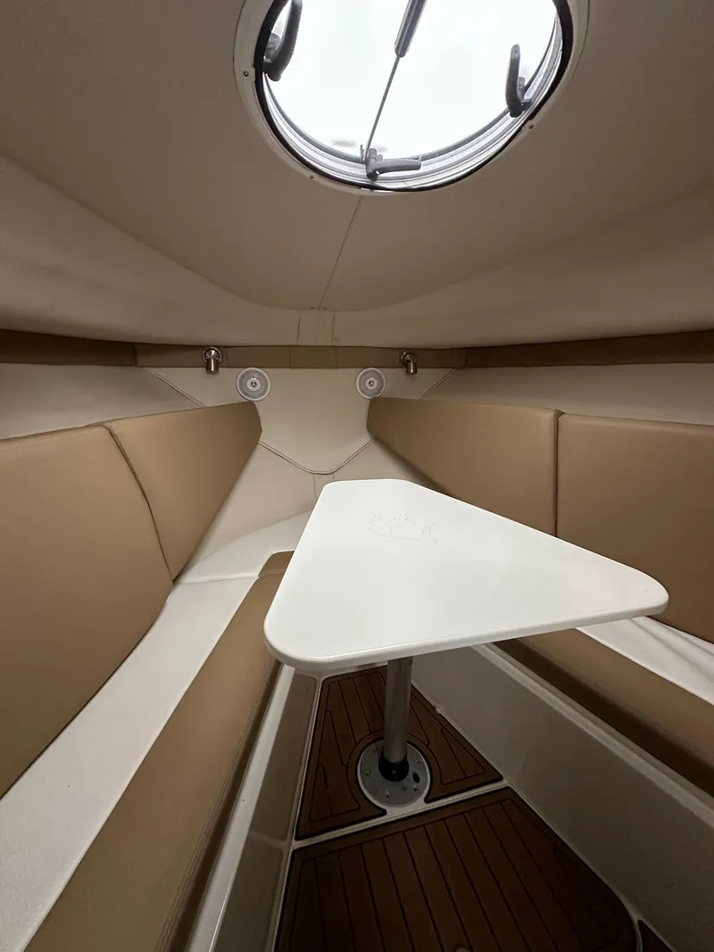 Slide: The Image of 2017 Striper 270 Walkaround cabin interior with seating and table. - 4