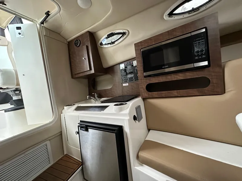 Slide: The Image of 2017 Striper 270 Walkaround cabin with kitchenette, microwave, and compact fridge. - 7
