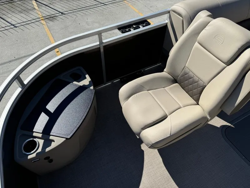 Slide: The Image of 2025 Sun Tracker 24 Sportfish XP3 boat interior with beige seating and console. - 11
