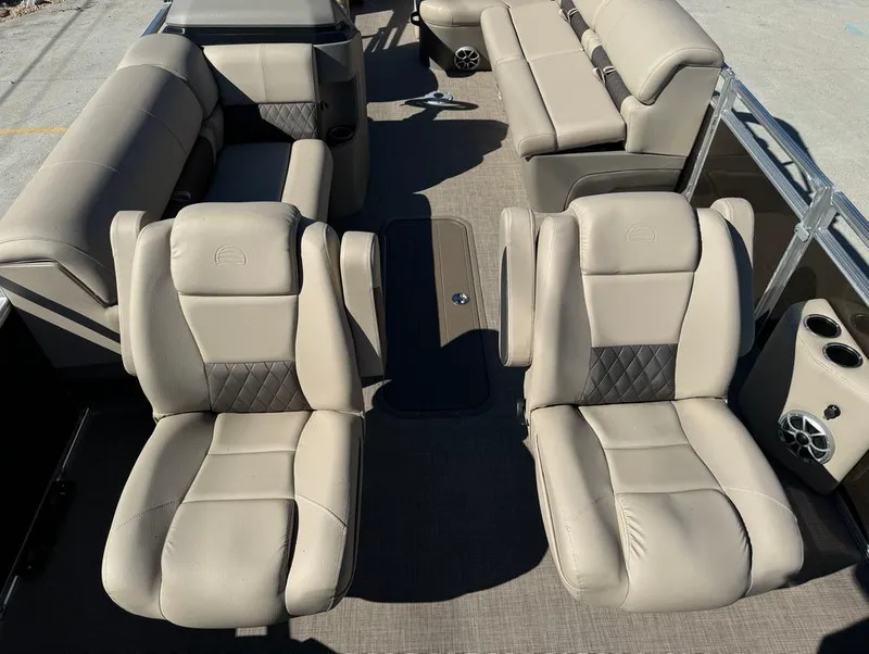 Slide: The Image of 2025 Sun Tracker 24 Sportfish XP3 interior with beige leather seating and spacious layout. - 13