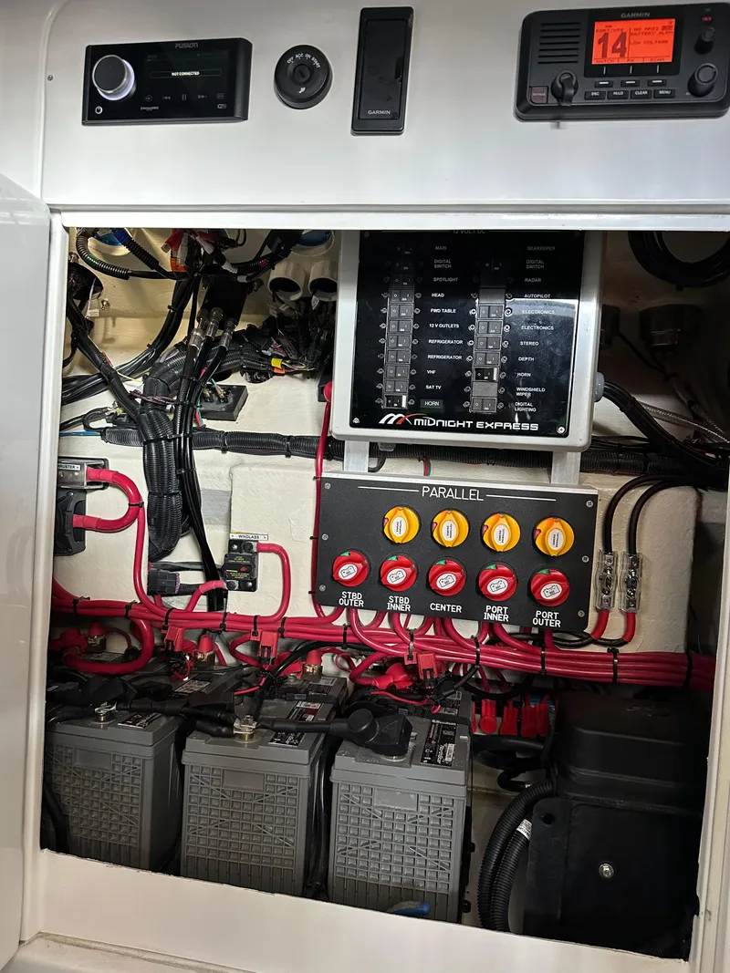 Slide: The Image of Electrical panel of 2022 Midnight Express 43 Solstice boat with wiring and battery setup. - 12