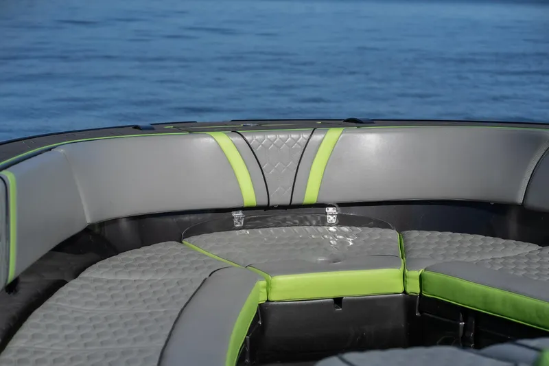 Slide: The Image of 2022 Midnight Express 43 Solstice boat interior with gray and green seating, on calm water. - 14