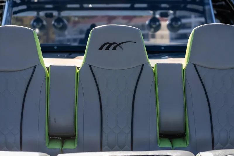 Slide: The Image of 2022 Midnight Express 43 Solstice boat seats with green accents and logo. - 16
