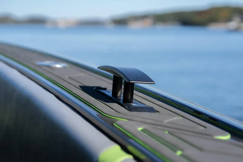 Slide: The Image of Close-up of 2022 Midnight Express 43 Solstice boat cleat against a serene water backdrop. - 20