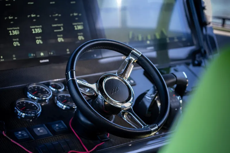 Slide: The Image of Steering wheel and dashboard of 2022 Midnight Express 43 Solstice boat. - 21