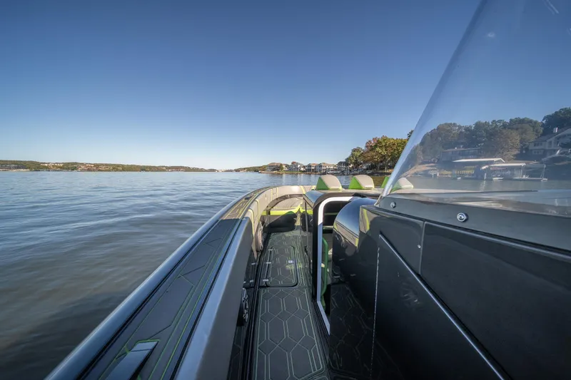 Slide: The Image of 2022 Midnight Express 43 Solstice boat on calm water, clear sky, side view. - 31