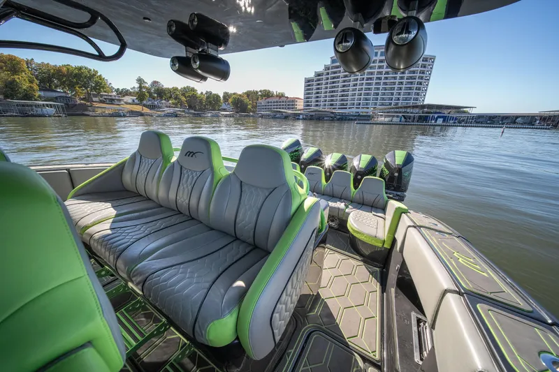 Slide: The Image of 2022 Midnight Express 43 Solstice boat with luxurious seating on a scenic lake. - 32