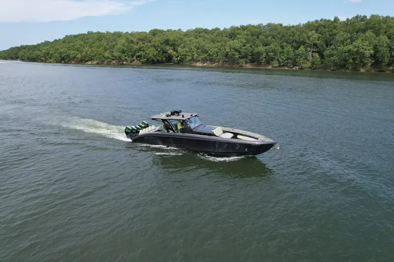 Slide: The Image of 2022 Midnight Express 43 Solstice boat cruising on a serene river. - 4