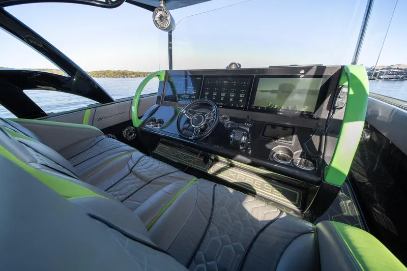 Slide: The Image of Interior of 2022 Midnight Express 43 Solstice boat with modern dashboard and green accents. - 41