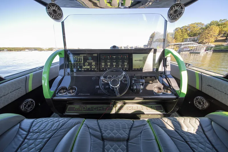 Slide: The Image of 2022 Midnight Express 43 Solstice boat cockpit with advanced controls and luxurious seating. - 46