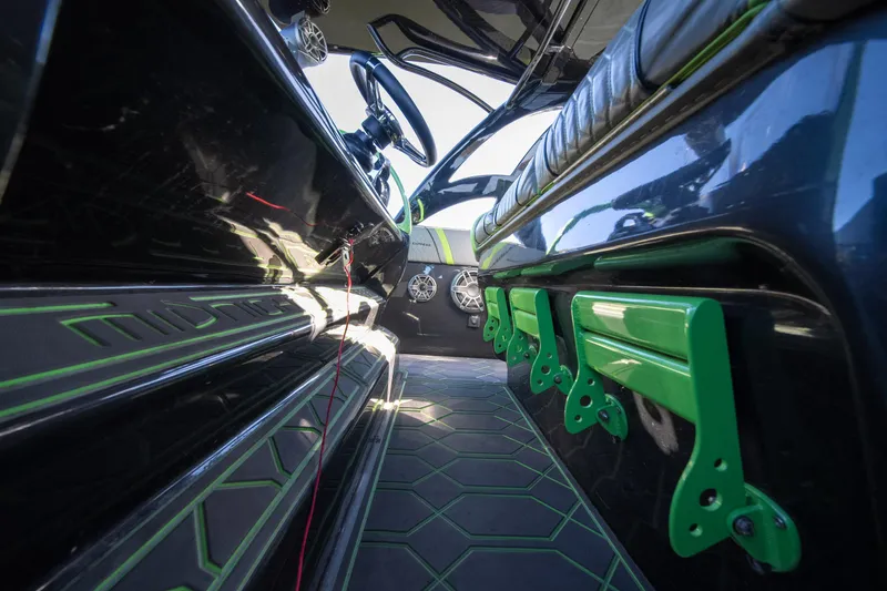 Slide: The Image of Interior of 2022 Midnight Express 43 Solstice boat with sleek design and green accents. - 48