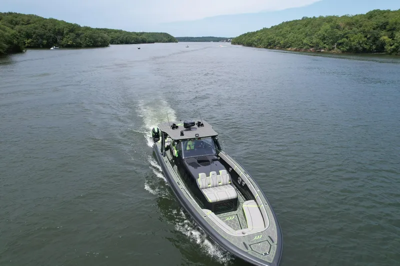 Slide: The Image of 2022 Midnight Express 43 Solstice cruising on a scenic river. - 5