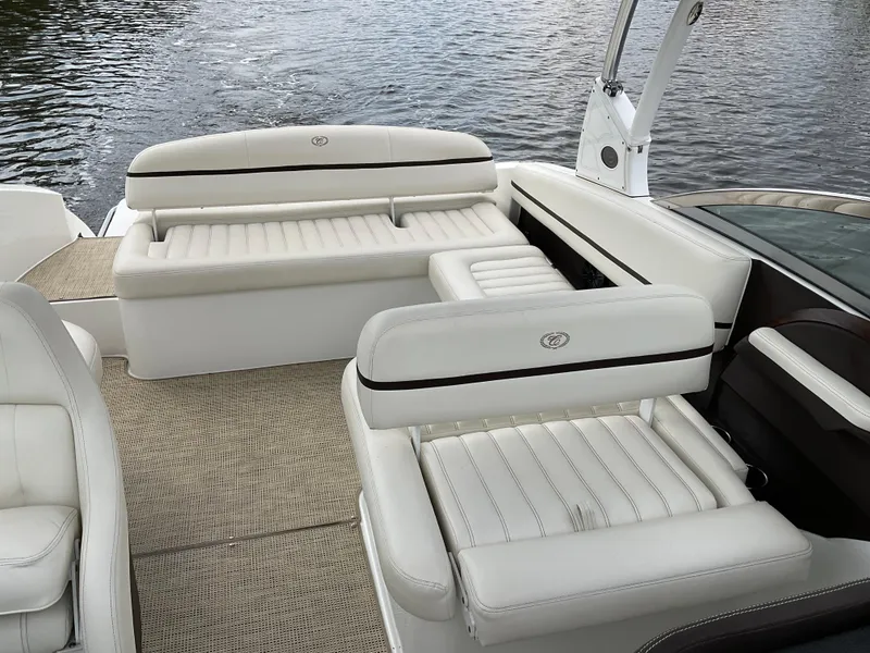 Slide: The Image of 2016 Cobalt R5 boat interior with white leather seating on a calm lake. - 6