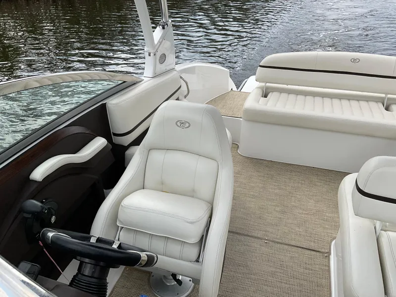 Slide: The Image of 2016 Cobalt R5 boat interior with white leather seats and steering wheel on water. - 7