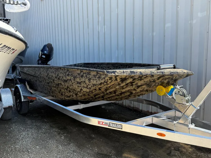 Slide: The Image of 2025 Edge Duck Boats 656DB on trailer, camouflage design, parked outdoors. - 3
