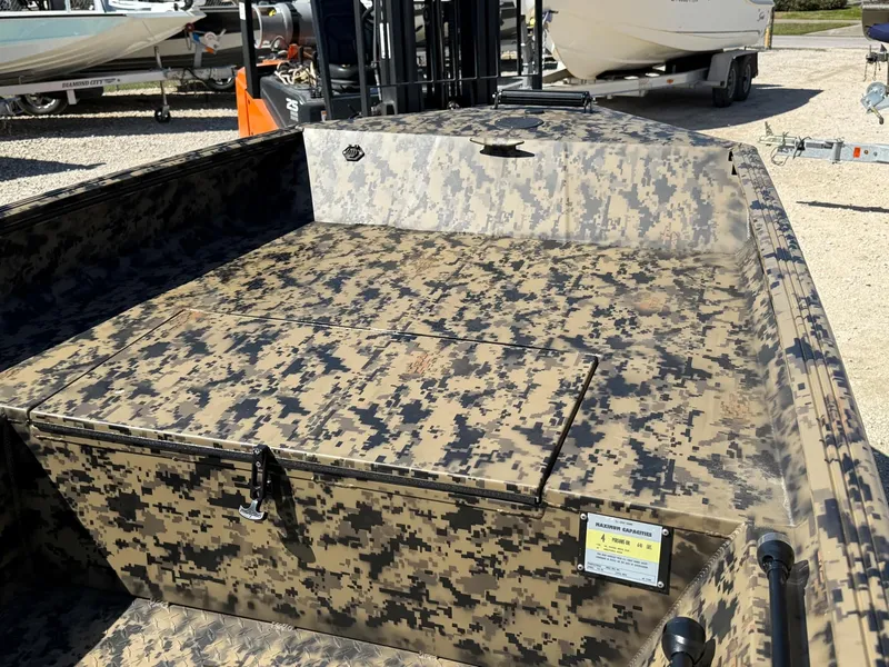 Slide: The Image of 2025 Edge Duck Boats 656DB with camouflage design, parked outdoors. - 6