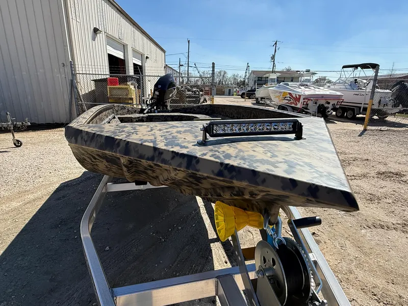 Slide: The Image of 2025 Edge Duck Boats 656DB on trailer, camo design, outdoor setting. - 8