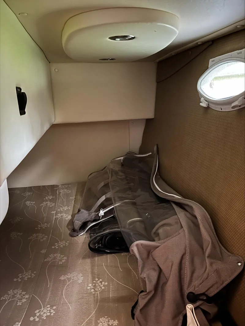 Slide: The Image of Interior cabin of 2008 Rinker 260 Express Cruiser with porthole and storage. - 12