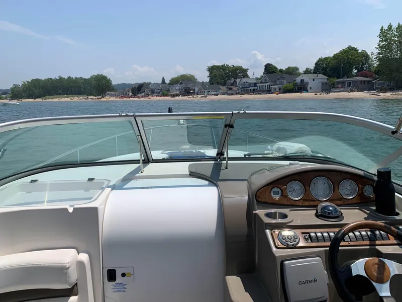 Slide: The Image of 2008 Rinker 260 Express Cruiser dashboard with scenic waterfront view. - 3