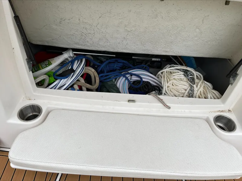 Slide: The Image of Storage compartment of 2008 Rinker 260 Express Cruiser with ropes and supplies. - 8