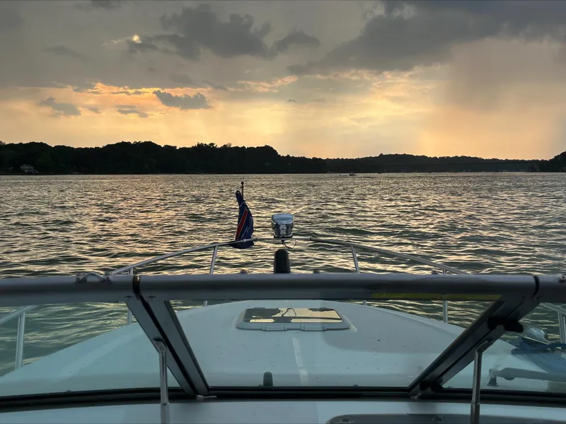 Slide: The Image of 2008 Rinker 260 Express Cruiser on a lake at sunset. - 9