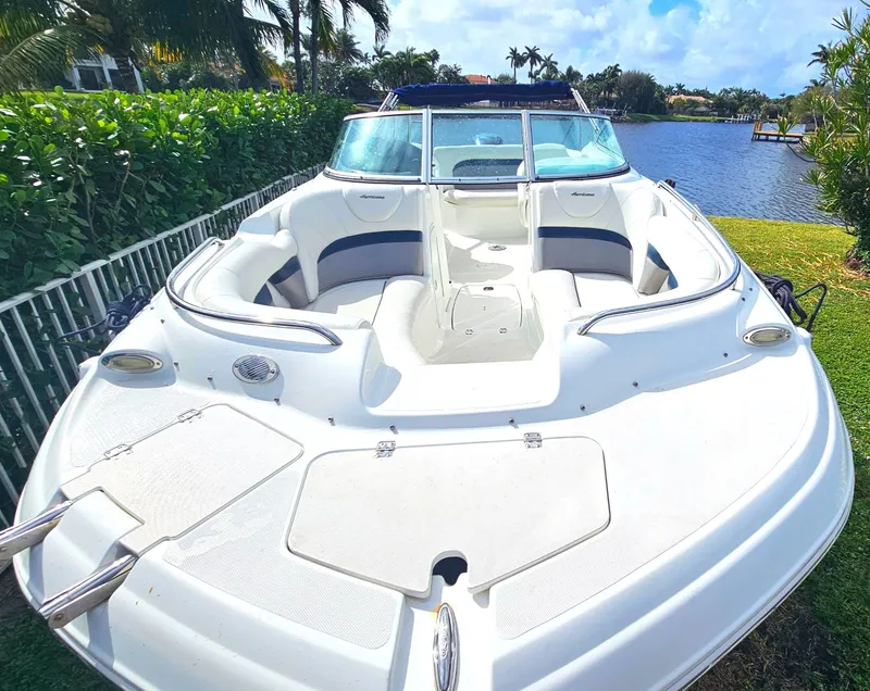 Slide: The Image of 2016 Hurricane SD2200 O/B boat docked by a scenic waterfront. - 13