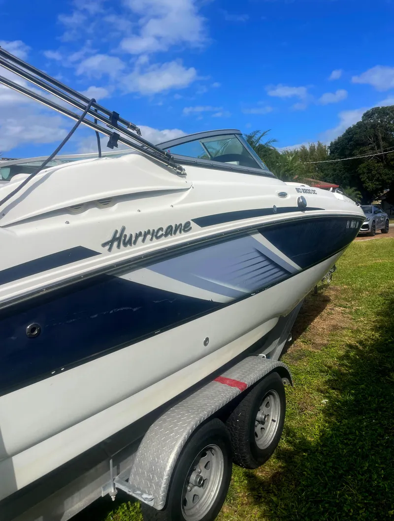 Slide: The Image of 2016 Hurricane SD2200 O/B boat on trailer, parked on grass under blue sky. - 4