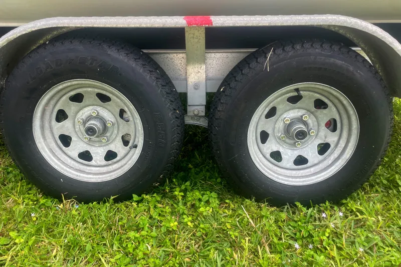 Slide: The Image of Trailer wheels on grass for 2016 Hurricane SD2200 O/B boat. - 7