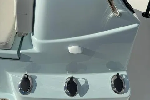 Slide: The Image of 2024 Action Craft 22 Coastal Bay boat console with control knobs and seating. - 17