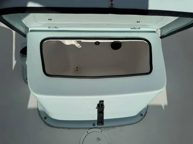 Slide: The Image of 2024 Action Craft 22 Coastal Bay storage compartment open on deck. - 18