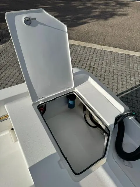 Slide: The Image of 2024 Action Craft 22 Coastal Bay boat storage compartment open on deck. - 24