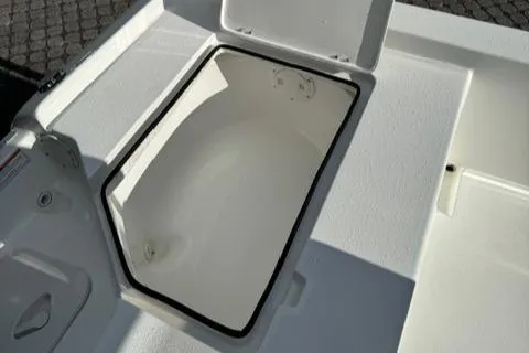 Slide: The Image of 2024 Action Craft 22 Coastal Bay boat storage compartment open. - 25