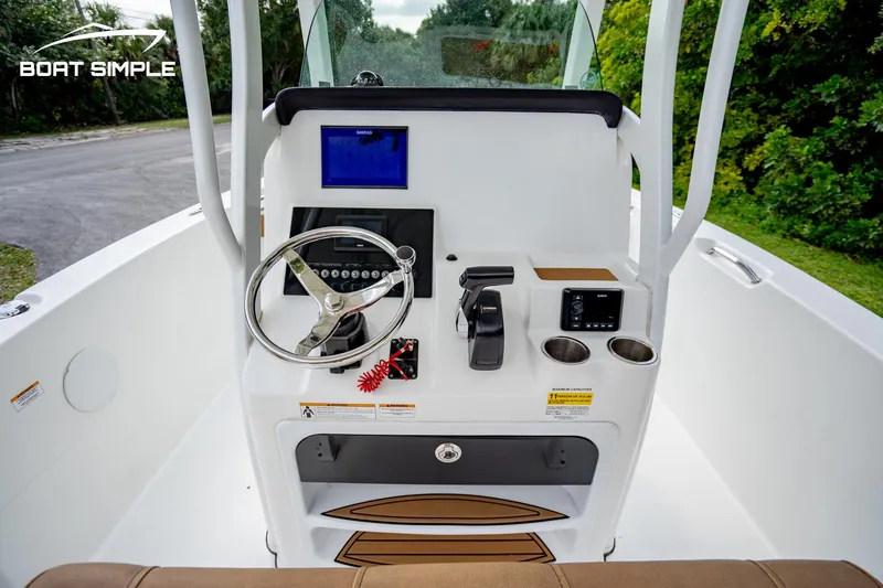 Slide: The Image of 2024 Sea Pro 239 Deep V CC boat console with steering wheel and controls. - 9