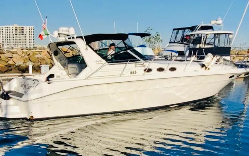 Slide: The Image of 1994 Sea Ray 400 Express Cruiser docked in marina, sunny day. - 1