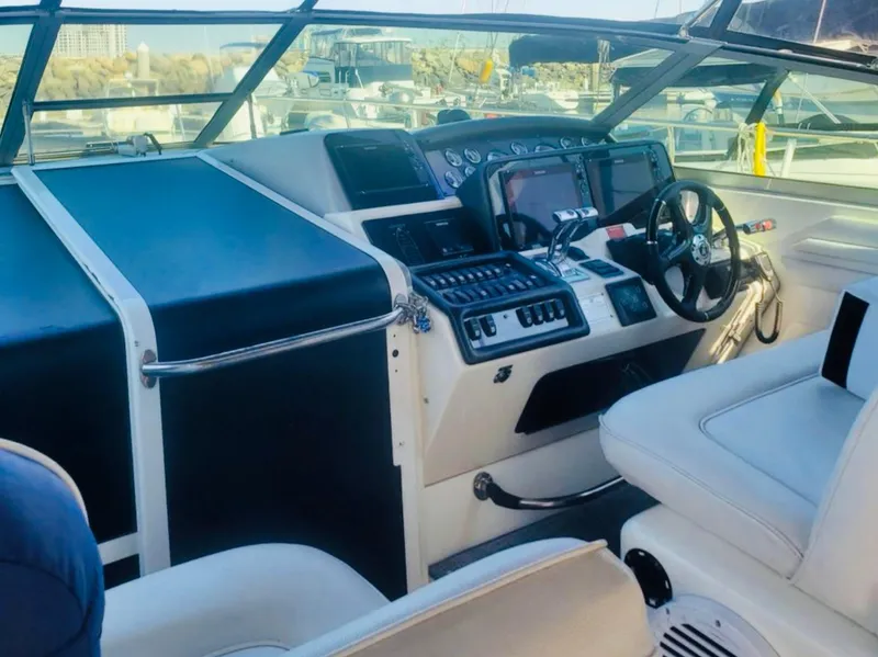 Slide: The Image of 1994 Sea Ray 400 Express Cruiser cockpit with modern controls and steering wheel. - 2