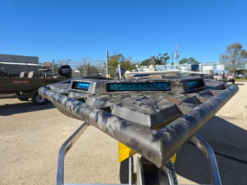 Slide: The Image of 2025 Edge Duck Boats ̃̀̉̃756DB with camouflage design, parked outdoors. - 10