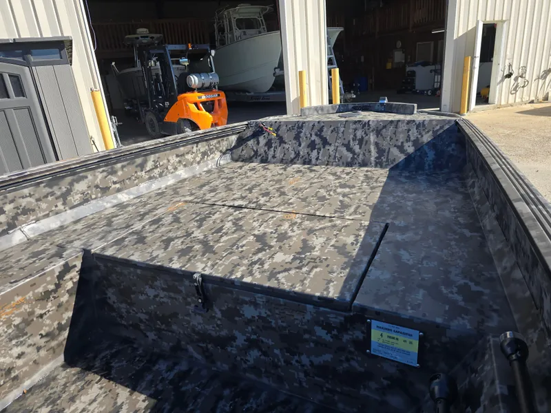 Slide: The Image of 2025 Edge Duck Boats ̃̀̉̃756DB with camouflage interior in a warehouse setting. - 11