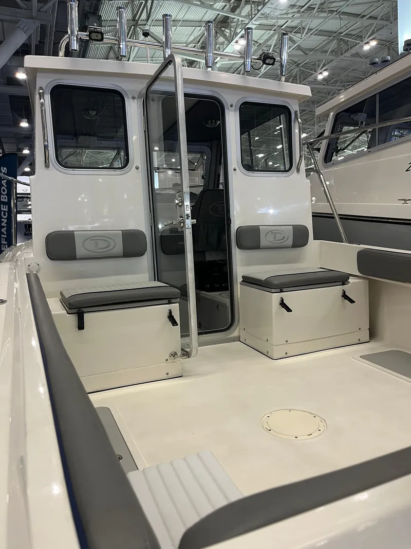 Slide: The Image of 2025 Defiance Admiral 220 EX boat interior with seating and storage. - 3