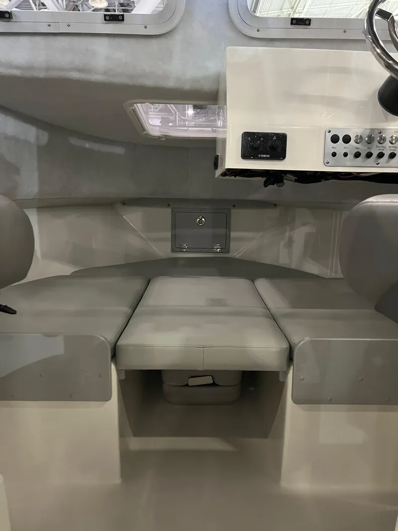 Slide: The Image of 2025 Defiance Admiral 220 EX cabin interior with cushioned seating and control panel. - 7