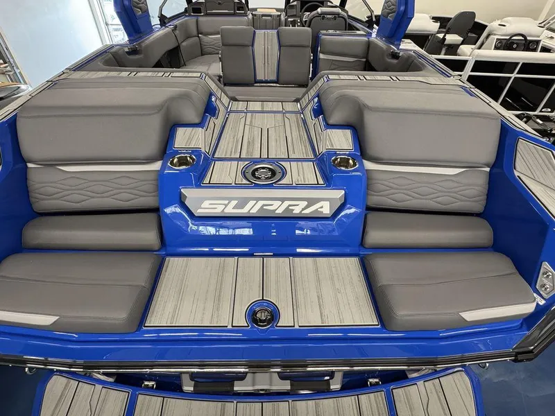 Slide: The Image of 2025 Supra SA 450 boat interior with gray seating and blue accents. - 13
